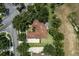 Aerial view of home featuring a brown roof, two-car driveway, fenced-in pool and luscious backyard at 2426 Breezy Meadow Rd, Apopka, FL 32712
