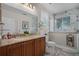 Elegant bathroom featuring double sinks, granite countertops, and a beautifully tiled shower at 2426 Breezy Meadow Rd, Apopka, FL 32712