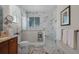 Stylish bathroom with a marble tiled shower, white towels, and modern fixtures at 2426 Breezy Meadow Rd, Apopka, FL 32712