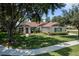 Traditional single-story home with a well-maintained lawn and mature landscaping at 2426 Breezy Meadow Rd, Apopka, FL 32712