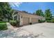 Spacious two-car garage with ample driveway space and tasteful exterior finishes at 2426 Breezy Meadow Rd, Apopka, FL 32712