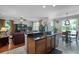 Gourmet kitchen island featuring granite countertops, stainless steel appliances, and an open layout at 2426 Breezy Meadow Rd, Apopka, FL 32712