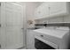 A well-lit laundry room with modern appliances and ample storage at 2426 Breezy Meadow Rd, Apopka, FL 32712