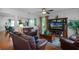 Comfortable living room with hardwood floors and plush leather furniture under a ceiling fan at 2426 Breezy Meadow Rd, Apopka, FL 32712