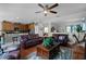 Spacious living room with hardwood floors, ceiling fan, and abundant natural light at 2426 Breezy Meadow Rd, Apopka, FL 32712