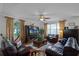 Comfortable living room featuring hardwood floors, large windows, and stylish decor at 2426 Breezy Meadow Rd, Apopka, FL 32712