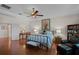 Comfortable main bedroom featuring hardwood floors, soft lighting, and a sitting area at 2426 Breezy Meadow Rd, Apopka, FL 32712