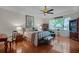 Spacious main bedroom with hardwood floors, tray ceilings, ceiling fan and ample natural light at 2426 Breezy Meadow Rd, Apopka, FL 32712