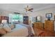 Bright main bedroom with hardwood floors, comfortable seating, and an ensuite bathroom at 2426 Breezy Meadow Rd, Apopka, FL 32712