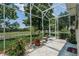 Screened lanai with a view of the lush green outdoors at 2426 Breezy Meadow Rd, Apopka, FL 32712