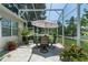 Screened-in patio with outdoor seating and lush greenery at 2426 Breezy Meadow Rd, Apopka, FL 32712