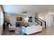 Bright living room features a decorative wall, contemporary furniture, and an adjacent staircase at 2525 Peace Of Mind Ave, Kissimmee, FL 34744