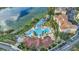 Resort-style pool and waterpark features by a lake, adjacent to apartments and community clubhouse at 2669 Manesty Ln, Kissimmee, FL 34747