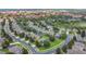 Aerial view of a residential area with well-manicured lawns, mature trees, and community pools at 2669 Manesty Ln, Kissimmee, FL 34747