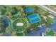Aerial view of community amenities including a park, tennis courts, and a basketball court at 2669 Manesty Ln, Kissimmee, FL 34747