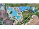 Aerial view showcasing a large community pool, water park, landscaping, and lounge areas at 2669 Manesty Ln, Kissimmee, FL 34747
