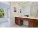 Well-lit bathroom featuring dual sinks, spacious vanity, and a separate shower area at 2669 Manesty Ln, Kissimmee, FL 34747