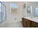 A clean and bright bathroom featuring a glass-enclosed shower and a dark wood vanity at 2669 Manesty Ln, Kissimmee, FL 34747