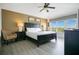 Comfortable bedroom features a ceiling fan, a large window, and stylish decor at 2669 Manesty Ln, Kissimmee, FL 34747
