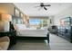 Comfortable bedroom with a king-sized bed, ceiling fan, and ample natural light at 2669 Manesty Ln, Kissimmee, FL 34747