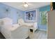 Bright, cheerful ' bedroom with twin beds, a light blue wall, and fun decor at 2669 Manesty Ln, Kissimmee, FL 34747