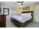 Comfortable bedroom with a king-sized bed, ceiling fan, and ample natural light at 2669 Manesty Ln, Kissimmee, FL 34747