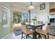Dining area with a view of the pool, dining table set for four, and bright natural light at 2669 Manesty Ln, Kissimmee, FL 34747