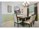 Dining room with a modern chandelier and view into kitchen at 2669 Manesty Ln, Kissimmee, FL 34747