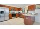 Modern kitchen with stainless steel appliances, granite countertops, and ample cabinet space at 2669 Manesty Ln, Kissimmee, FL 34747