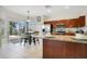 Modern kitchen with stainless steel appliances, granite countertops, and a view into the dining area at 2669 Manesty Ln, Kissimmee, FL 34747