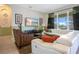 Inviting living room featuring a comfortable white sectional and a large window with natural light at 2669 Manesty Ln, Kissimmee, FL 34747
