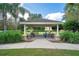 Outdoor picnic pavilion with charcoal grills, tables, and lush landscaping, great for community gatherings at 2669 Manesty Ln, Kissimmee, FL 34747