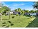 Spacious backyard featuring a well-maintained lawn and screened-in pool area with solar panels at 2919 Foraker Way, Kissimmee, FL 34758