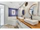 Modern bathroom with double sinks, wood counters, stylish mirrors, and a luxurious soaking tub for relaxation at 2919 Foraker Way, Kissimmee, FL 34758