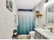 Fresh bathroom featuring a shower with tub, white and blue decorative shower curtain and decor at 2919 Foraker Way, Kissimmee, FL 34758