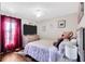 Cozy bedroom with wood floors, bright window, and comfortable queen-sized bed for restful nights at 2919 Foraker Way, Kissimmee, FL 34758