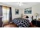 Charming bedroom with wood floors, bright window, and comfortable queen-sized bed for restful nights at 2919 Foraker Way, Kissimmee, FL 34758