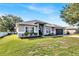Attractive single-story home featuring manicured landscaping, updated paint, and an attached two-car garage at 2919 Foraker Way, Kissimmee, FL 34758