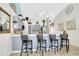 Stylish kitchen features a breakfast bar with seating, gray cabinets, stainless appliances, and tile floors at 2919 Foraker Way, Kissimmee, FL 34758