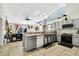 Modern kitchen with stainless steel appliances, gray cabinetry, a breakfast bar, and tile flooring at 2919 Foraker Way, Kissimmee, FL 34758