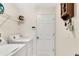 Bright laundry room featuring white washer and dryer with plenty of storage and lighting at 2919 Foraker Way, Kissimmee, FL 34758