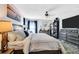 Spacious main bedroom featuring a comfortable bed, soft lighting, and dresser with large screen television at 2919 Foraker Way, Kissimmee, FL 34758