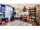 Well-lit home office with a modern desk, comfortable chair, hardwood floors, and ample natural light at 2919 Foraker Way, Kissimmee, FL 34758