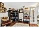 Cozy home office featuring hardwood floors, lots of decor, unique shelving and a comfortable accent chair at 2919 Foraker Way, Kissimmee, FL 34758