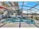 An inviting screened-in pool with a fountain feature and meticulously landscaped surroundings at 2919 Foraker Way, Kissimmee, FL 34758