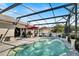 Backyard swimming pool inside screened enclosure, and is equipped with solar panels for heating at 2919 Foraker Way, Kissimmee, FL 34758
