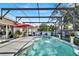 Backyard swimming pool inside screened enclosure features a fountain, and outdoor furniture at 2919 Foraker Way, Kissimmee, FL 34758