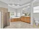 Bright bathroom with soaking tub, walk-in shower, large mirror, and neutral-toned tiles at 307 Running Wind Ln, Maitland, FL 32751