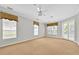 Large, empty bedroom with ample natural light, French doors, and neutral carpeting at 307 Running Wind Ln, Maitland, FL 32751