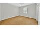 Neutral carpeted bedroom with a ceiling fan and a window for natural light at 307 Running Wind Ln, Maitland, FL 32751